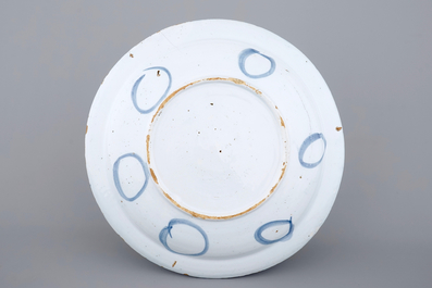 A good Dutch Delft blue and white chinoiserie dish with a lion, 17/18th C.